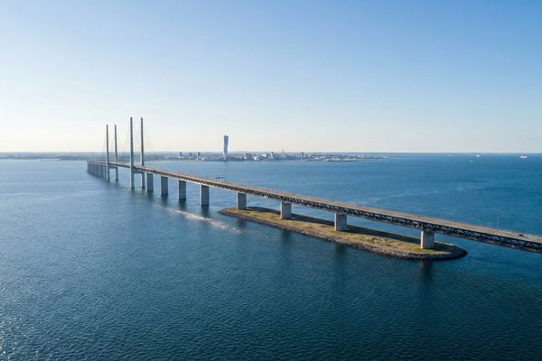 Oresund Bridge connecting Denmark and Sweden with Malmo skyline